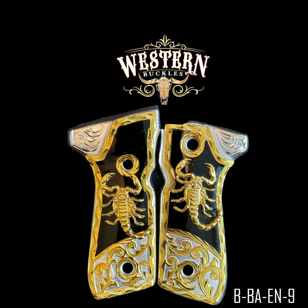 Gold and black Colt 1911 pistol grips with scorpion design and engraved details