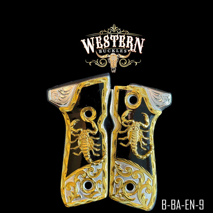 Gold and black Colt 1911 pistol grips with scorpion design and engraved details