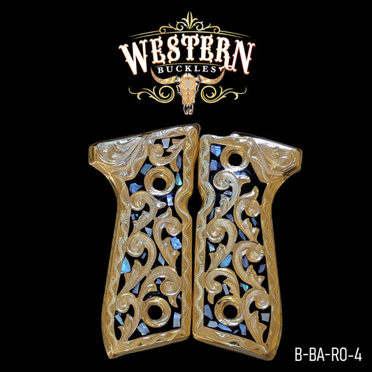 Ornate gold and black Colt 1911 pistol grips with engraved floral design and abalone inlay.
