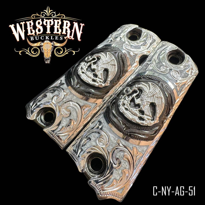 Engraved silver Colt 1911 pistol grips with eagle design and western scroll details