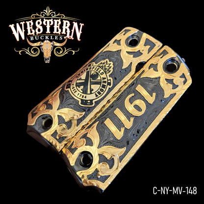 Decorative gold and black Colt 1911 pistol grips with ornate western pattern and 1911 engraving