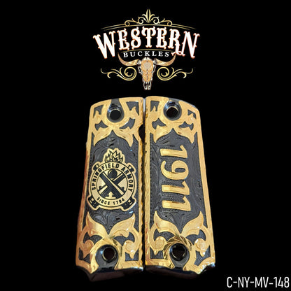 Custom gold and black Colt 1911 pistol grips with Springfield Armory design, engraved details.