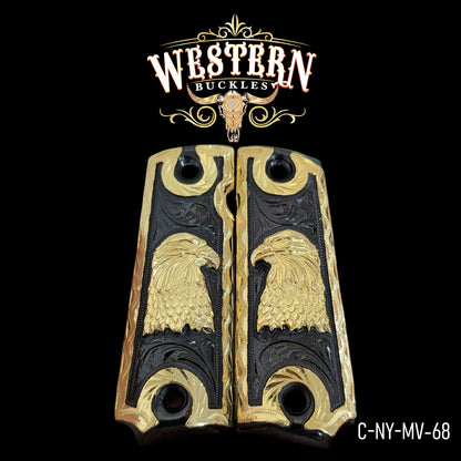 Gold and black Colt 1911 pistol grips with engraved eagle design, decorative gun accessories.
