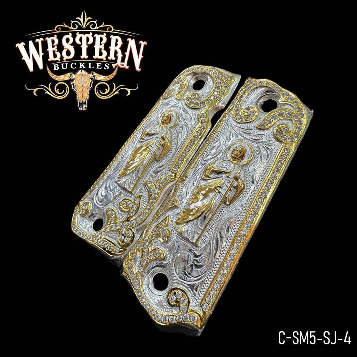 Engraved gold and silver 1911 pistol grips with ornate western design and religious figure.