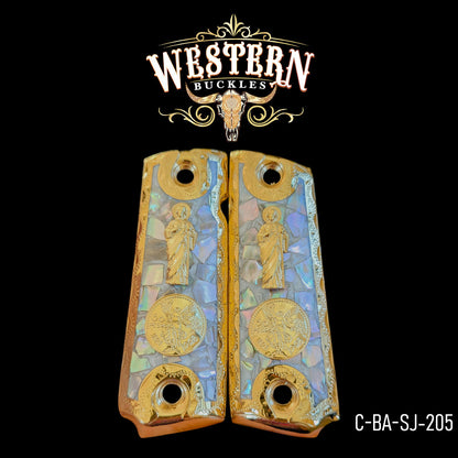 Custom Colt 1911 pistol grips with gold and mother of pearl design, engraved saint and coin details