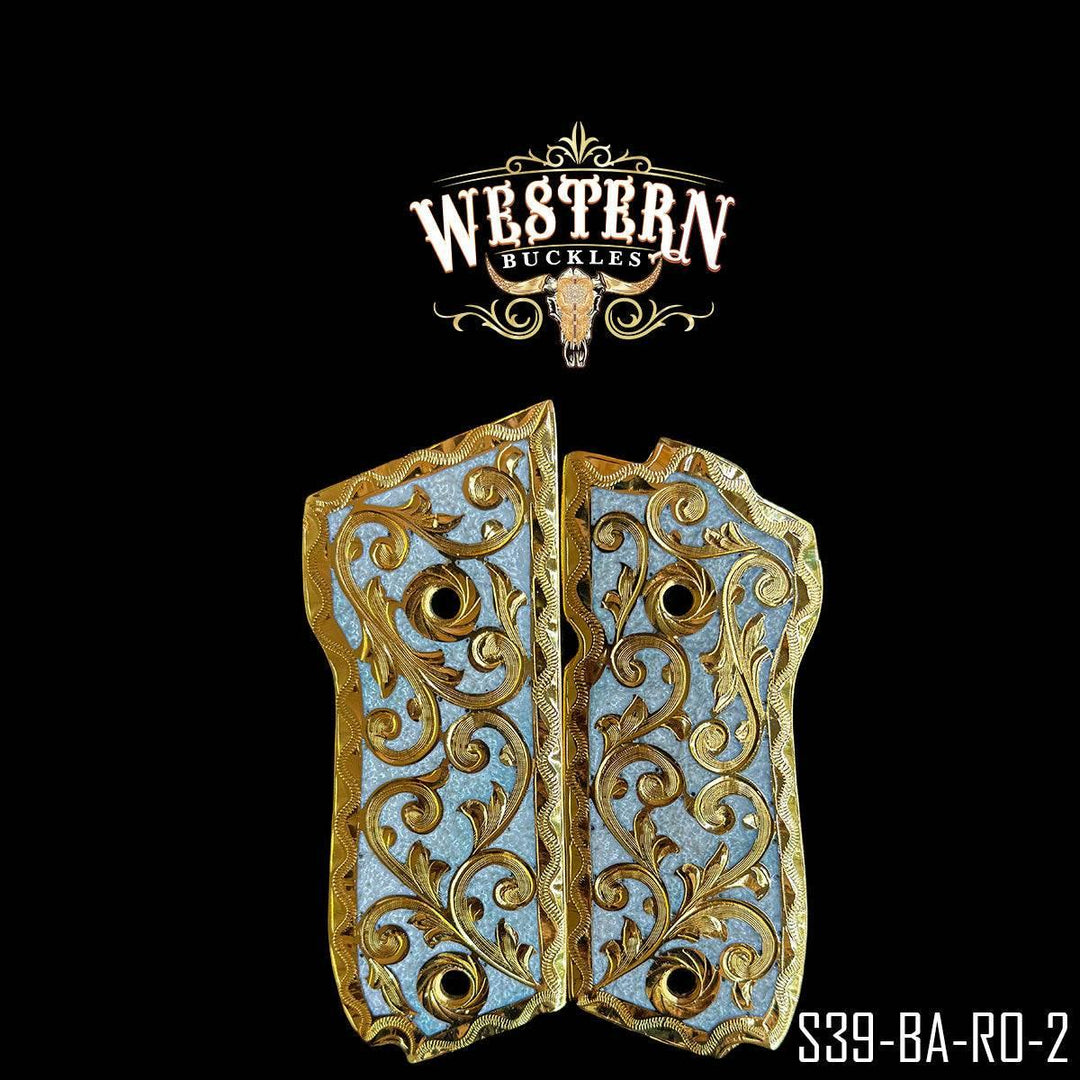 Custom Colt 1911 pistol grips with engraved gold and silver western floral design.