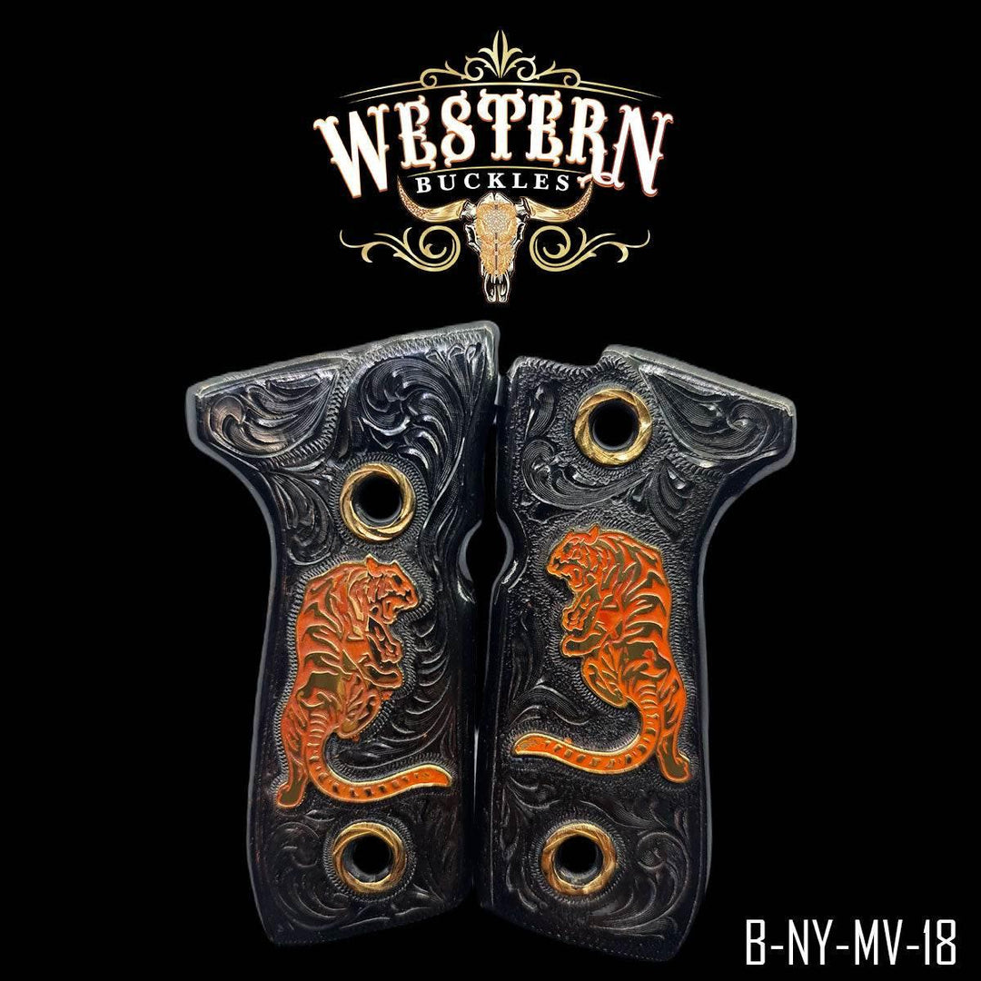 Black engraved Colt 1911 pistol grips with orange tiger design and gold accents.